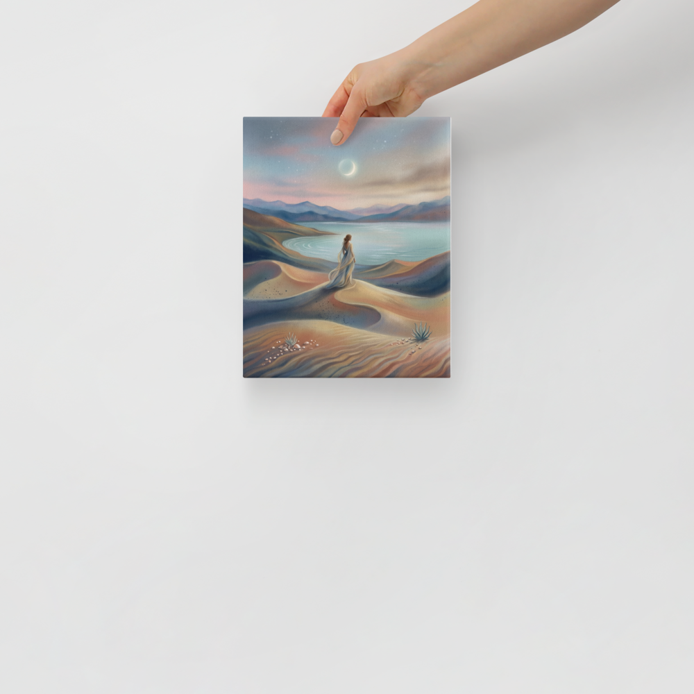'Desert Moonrise' — a Magic realism print. A woman in a flowing dress standing on rolling sand dunes looking over a turquoise bay toward mountains under a twilight sky with a crescent moon.