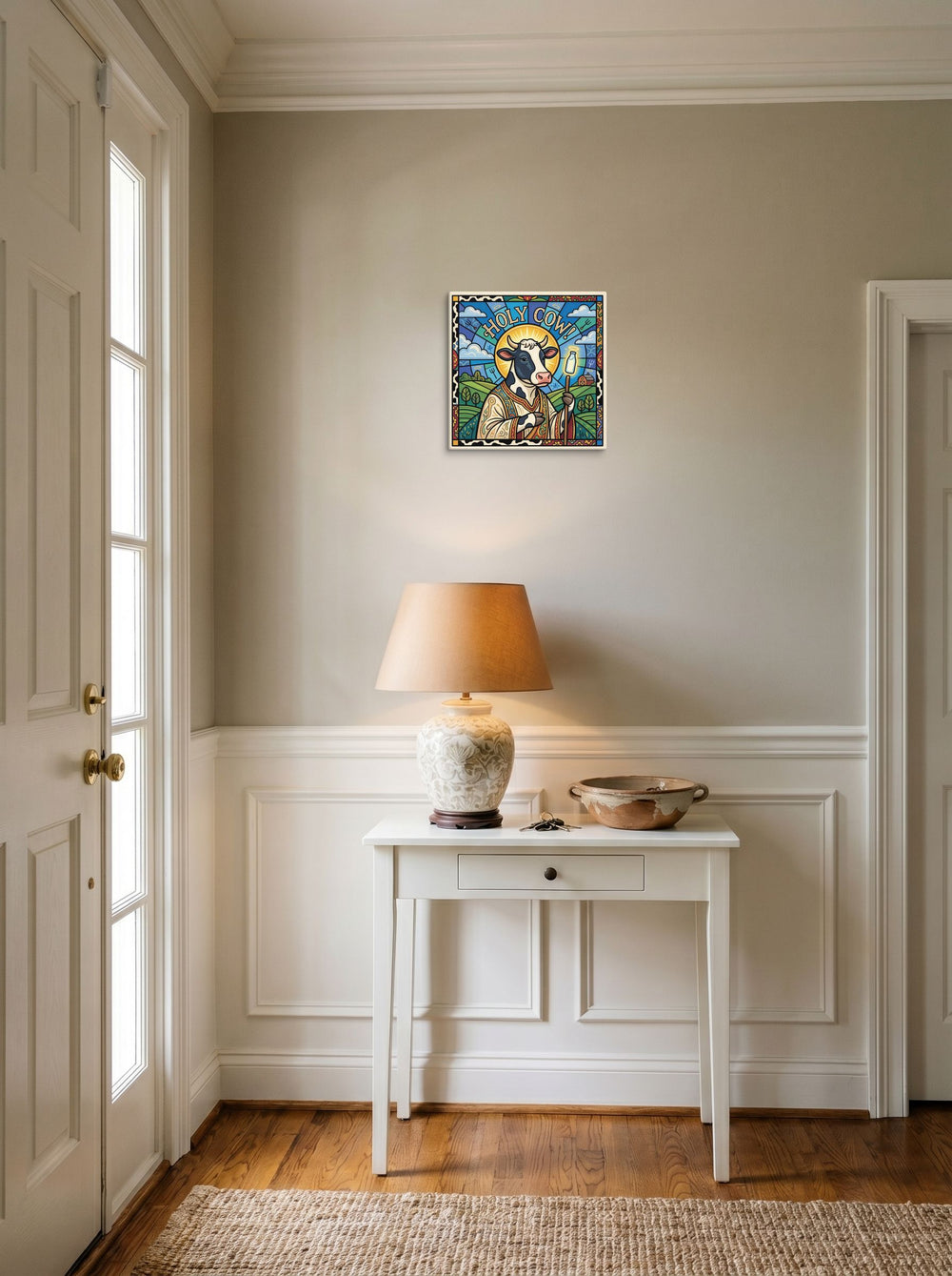 A canvas print of the Pop art artwork 'Holy Cow!', hanging in an entryway near a console.