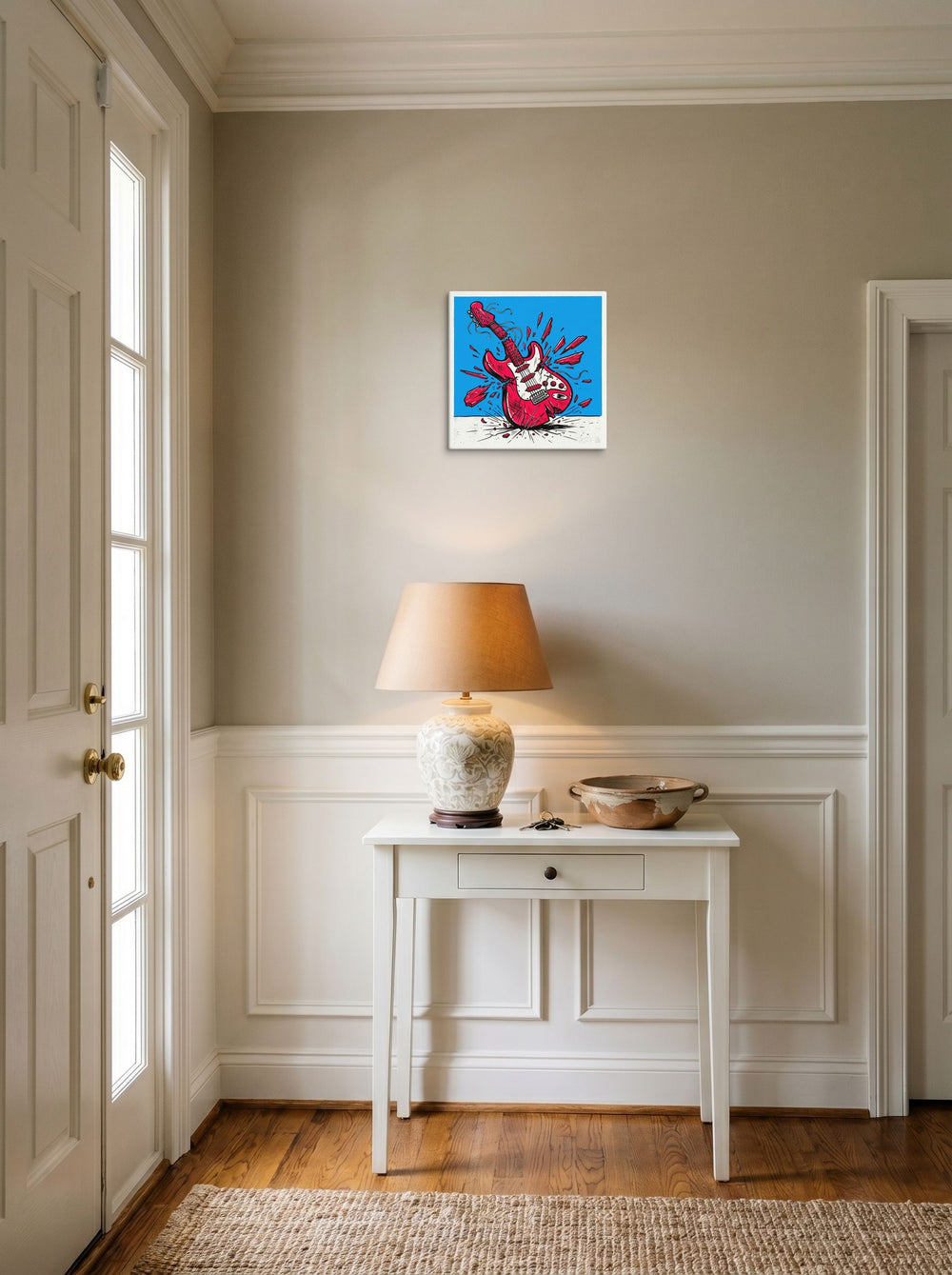 A 12x12 inch canvas Pop art print of 'Guitar Smash' hanging in an entryway near a console.