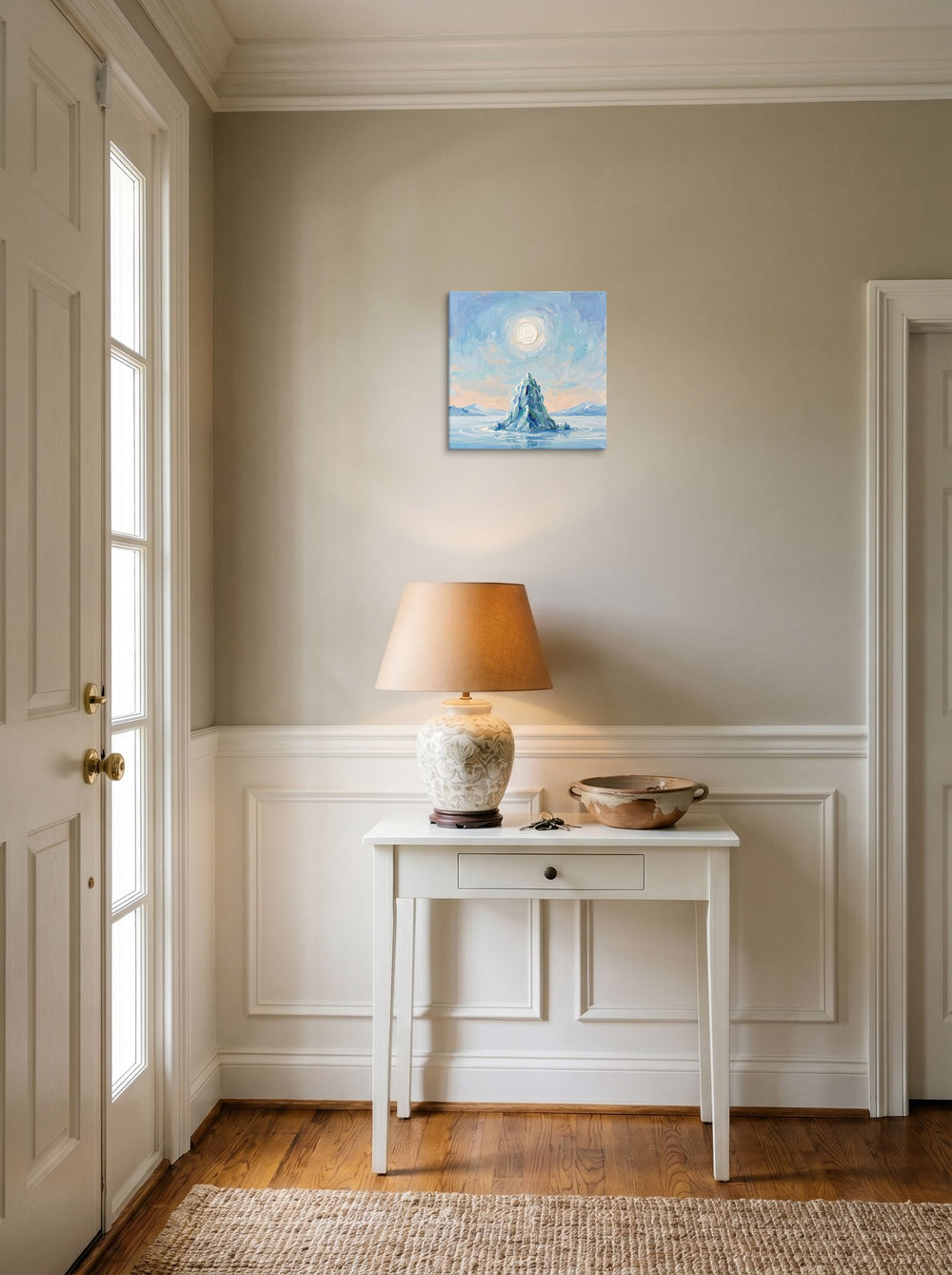 A 12x12 inch canvas Impressionism print of 'Frozen Peak' hanging in an entryway near a console.