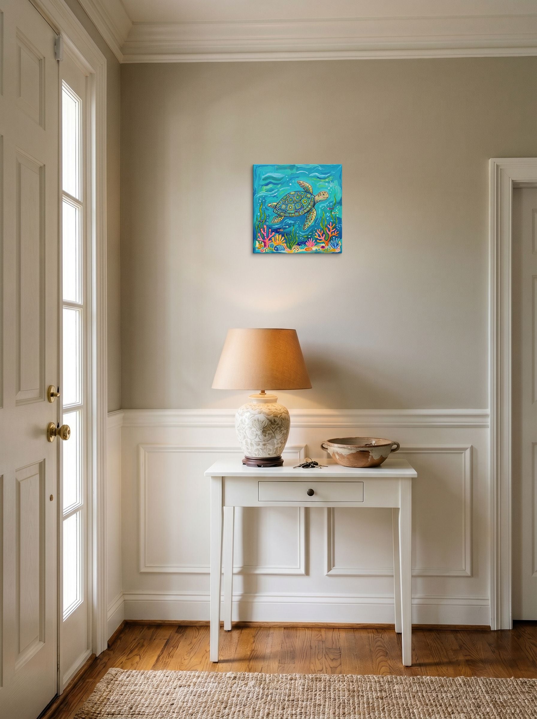A 12x12 inch canvas Naive art print of 'The Painted Sea Turtle' hanging in an entryway near a console.