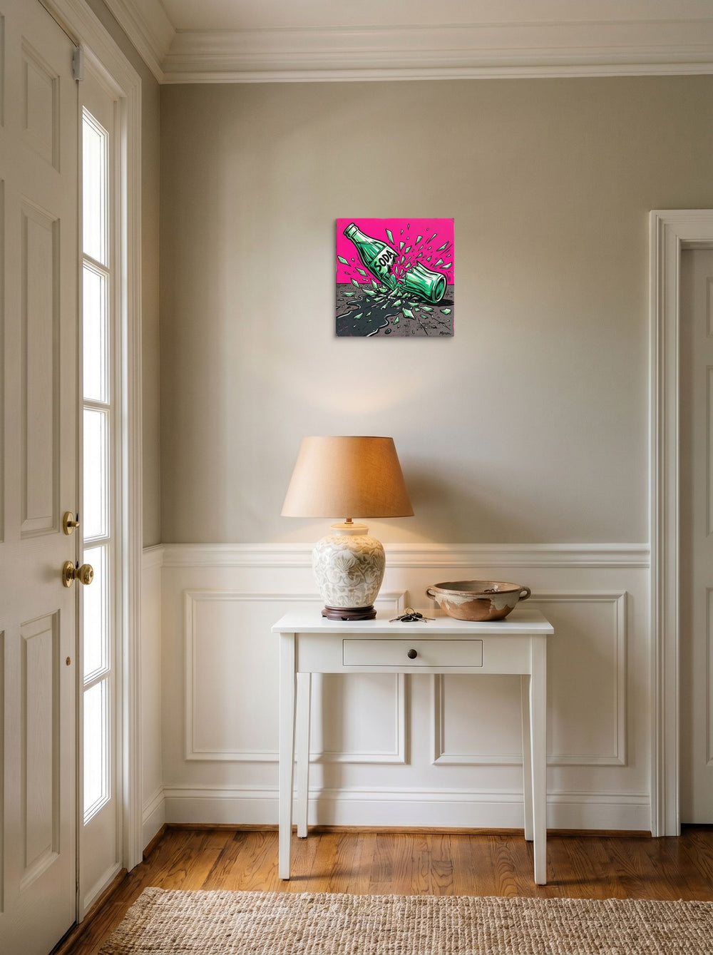 A 12x12 inch canvas Pop art print of 'Shattered Soda' hanging in an entryway near a console.