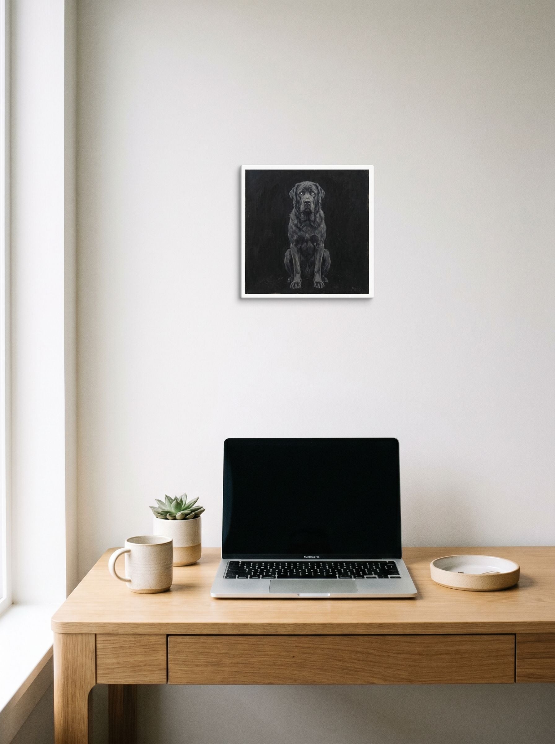A 12x12 inch canvas Figurative art,Surrealism print of 'The Obsidian Guardian' hanging above a worktable with a laptop.