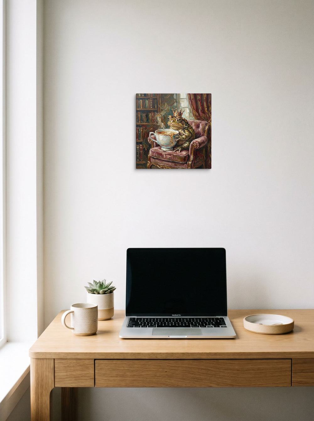 A 12x12 inch canvas Lowbrow,Pop art print of 'Royal Brew' hanging above a worktable with a laptop.