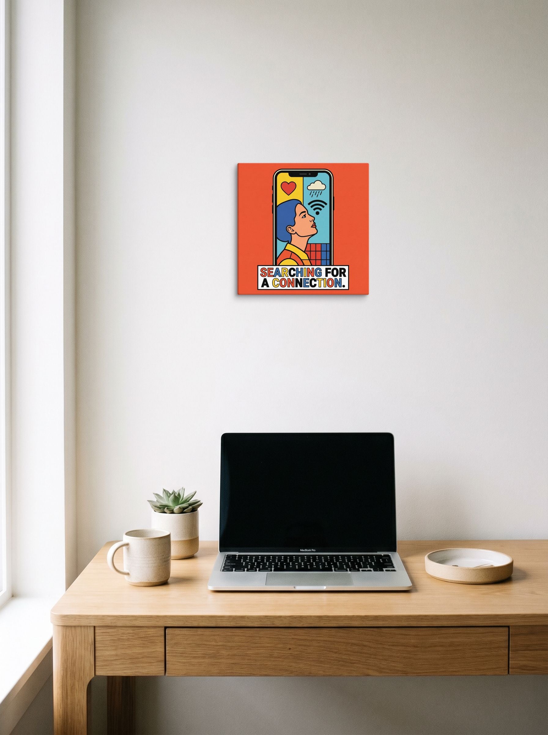 A 12x12 inch canvas Pop art print of 'Signal Lost' hanging above a worktable with a laptop.