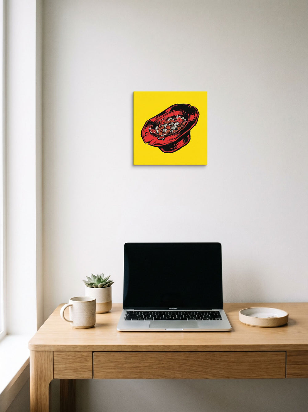 A 12x12 inch canvas Pop art print of 'The Busker's Fortune' hanging above a worktable with a laptop.