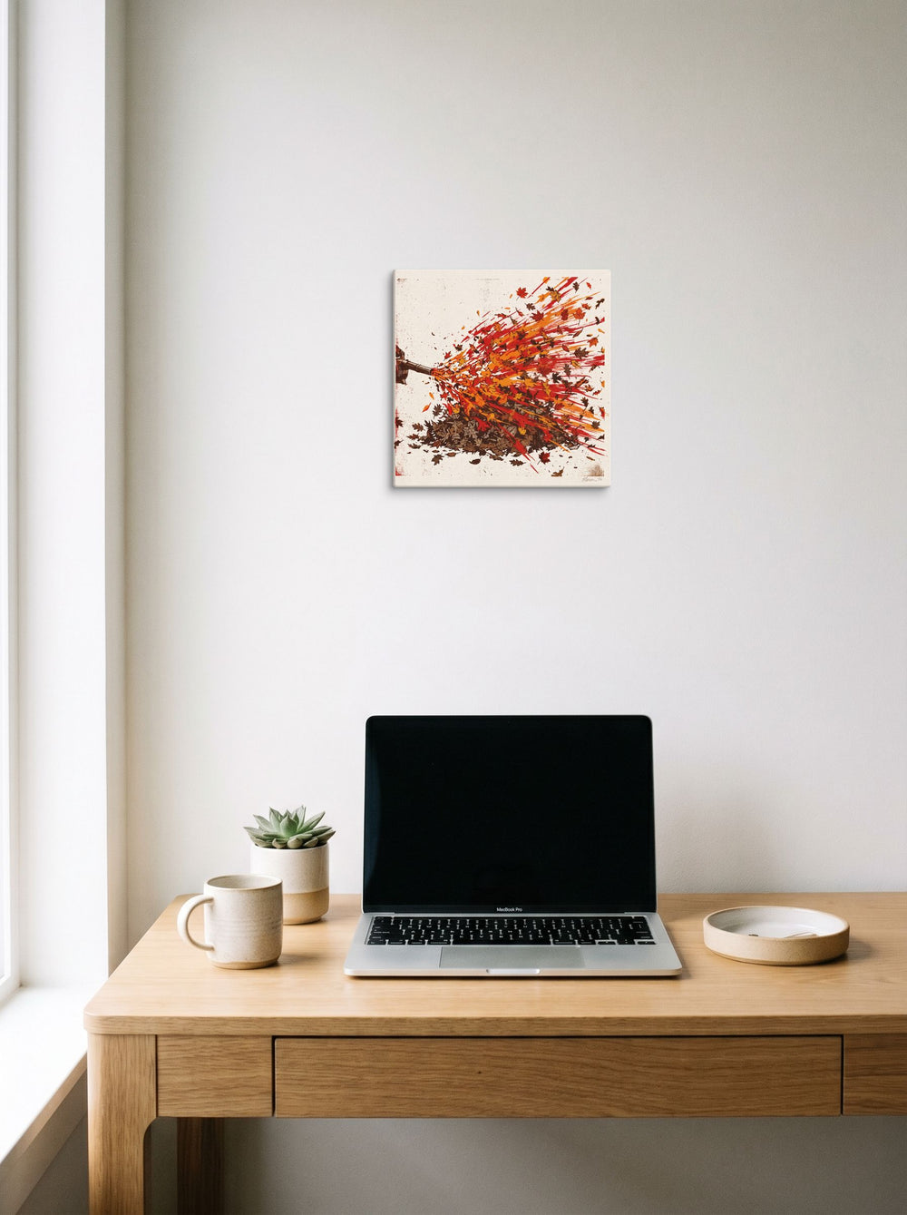 'Autumn Blast' in 12x12 inch canvas, hanging above a worktable with a laptop.