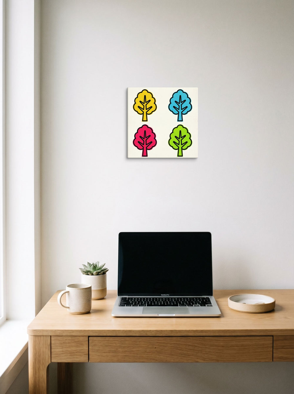 A 12x12 inch canvas Pop art print of 'Pop Art Forest Grid' hanging above a worktable with a laptop.