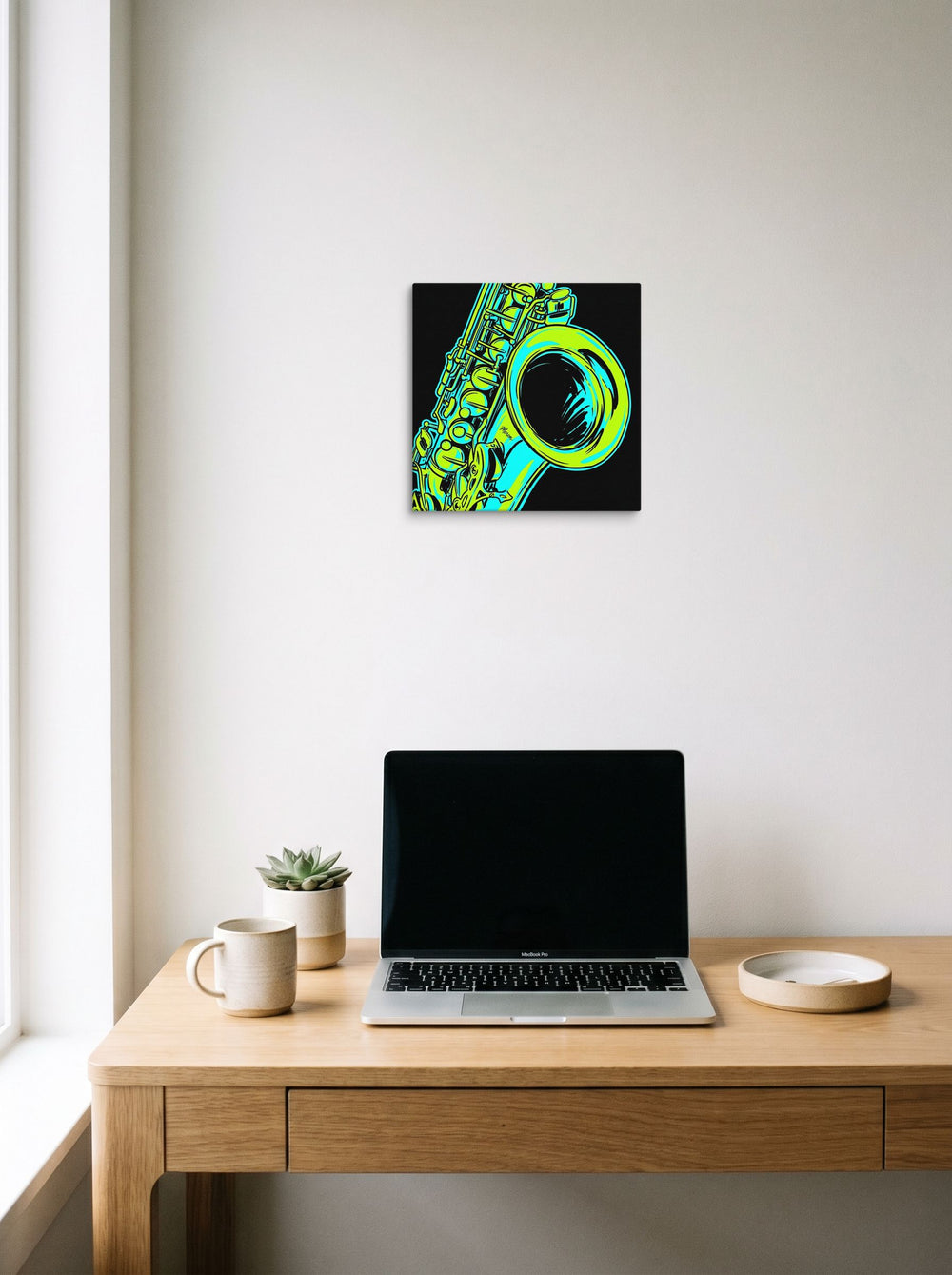 A 12x12 inch canvas Pop art print of 'Neon Rhythms' hanging above a worktable with a laptop.