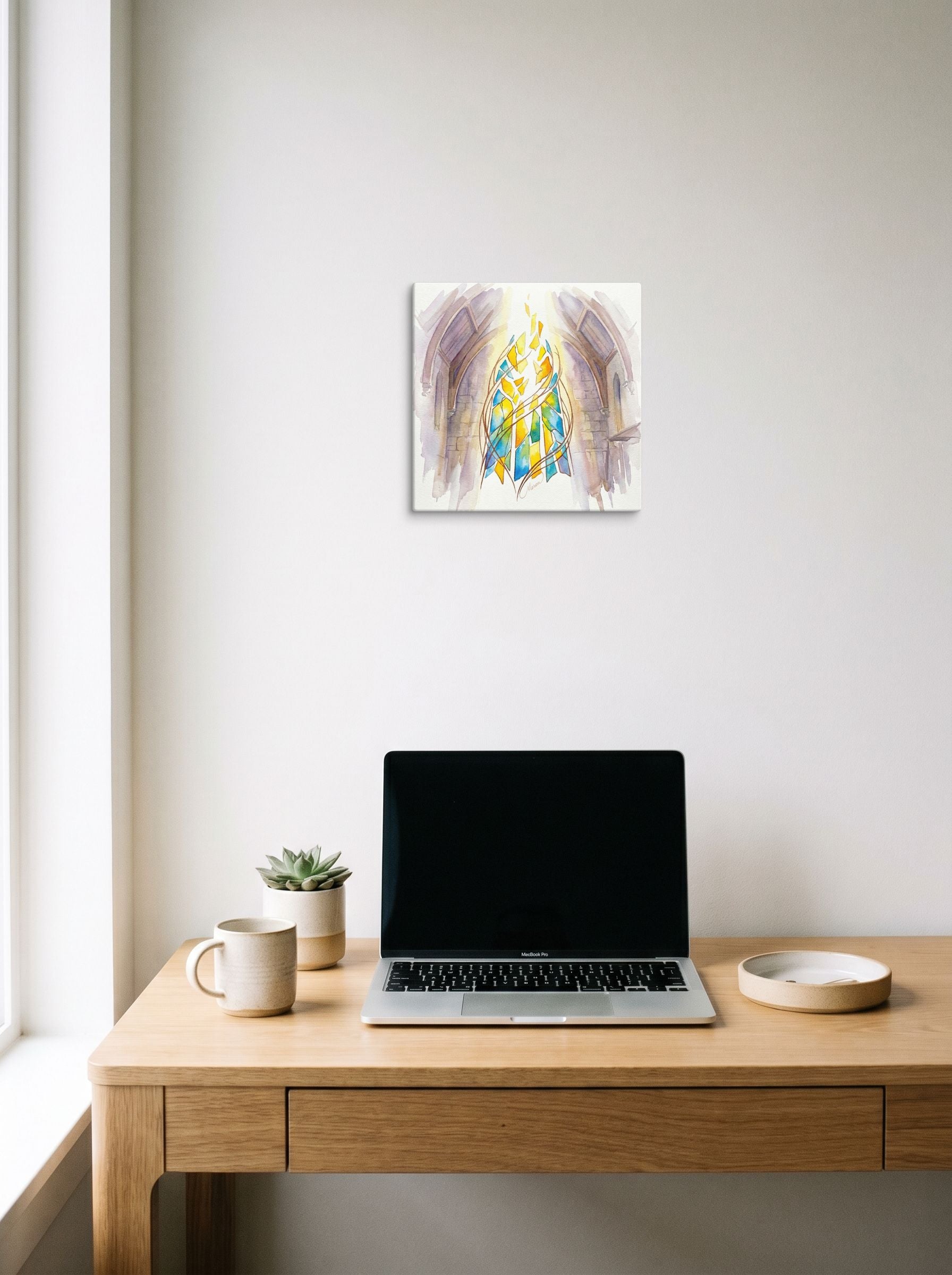 A 12x12 inch canvas Abstract art,Gothic art print of 'Ascendant Light' hanging above a worktable with a laptop.