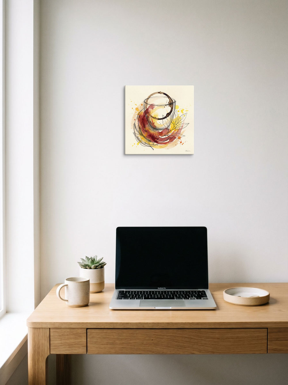 Fine Art wall art 'Notes of Cabernet', canvas at 12x12 inch, hanging above a worktable with a laptop.