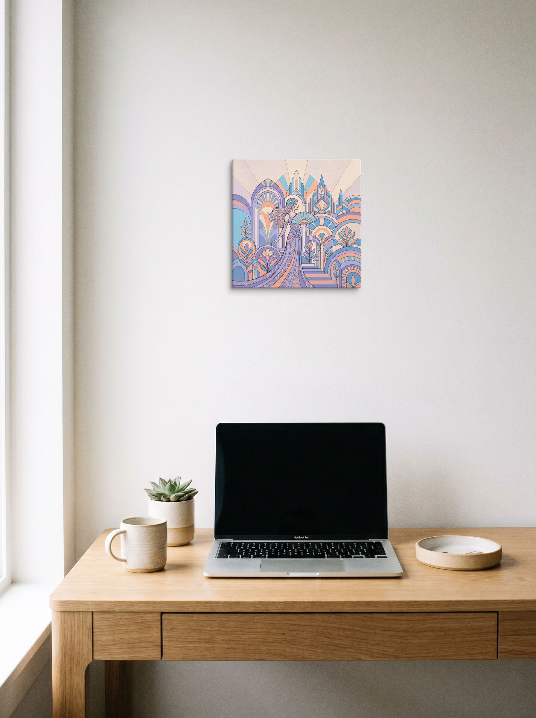 A 12x12 inch canvas Art Deco print of 'Pastel Metropolis Glamour' hanging above a worktable with a laptop.
