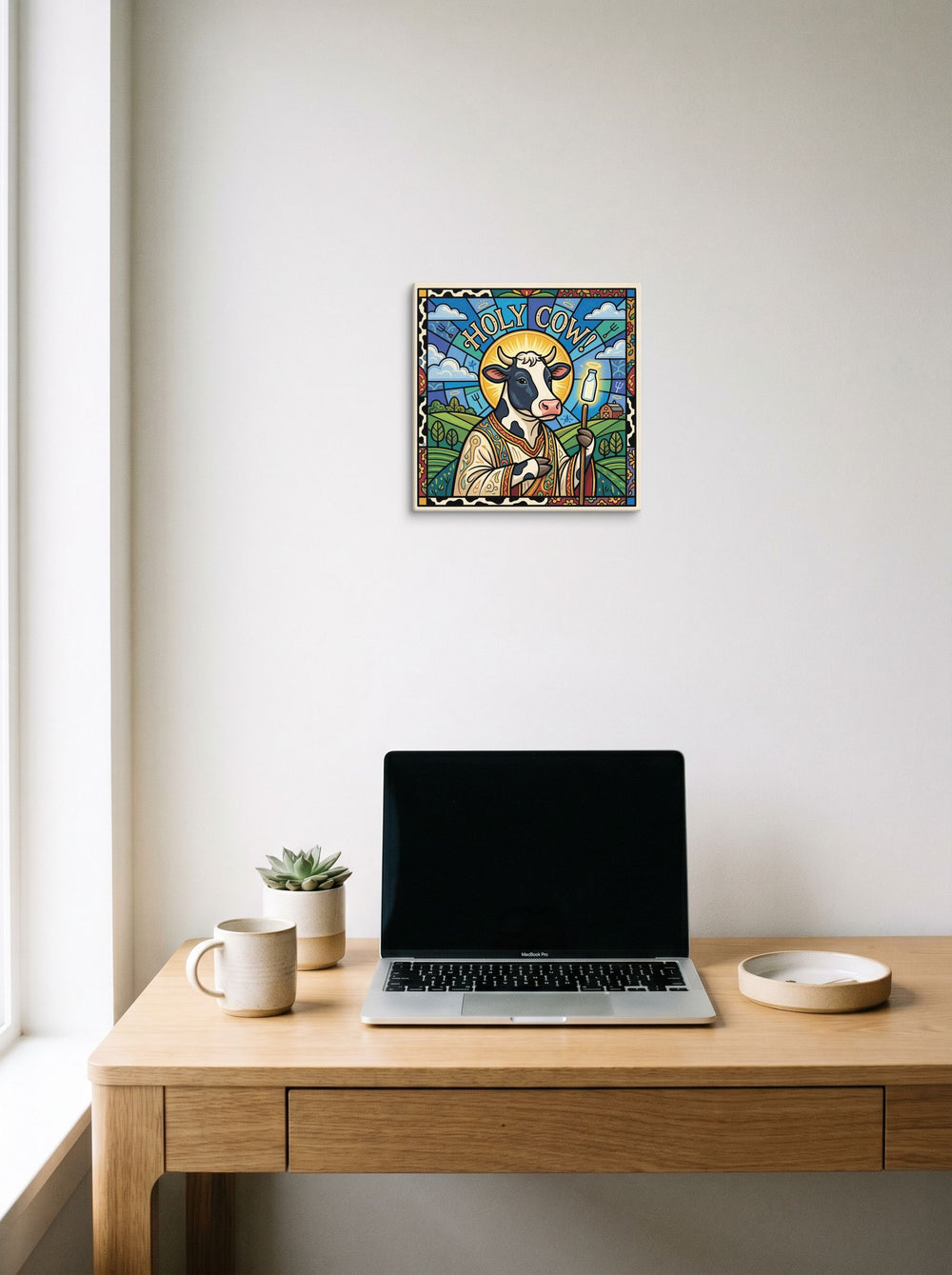 'Holy Cow!' hanging above a worktable with a laptop. A 12x12 inch canvas Pop art print.