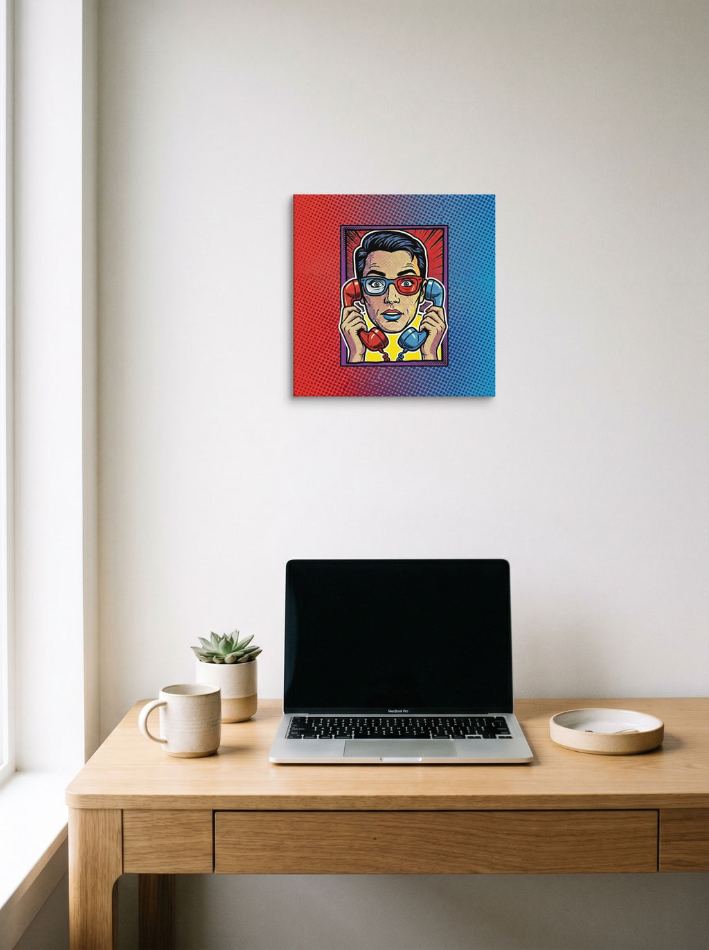 A 14x14 inch canvas Pop art print of 'Bipartisan Static' hanging above a worktable with a laptop.