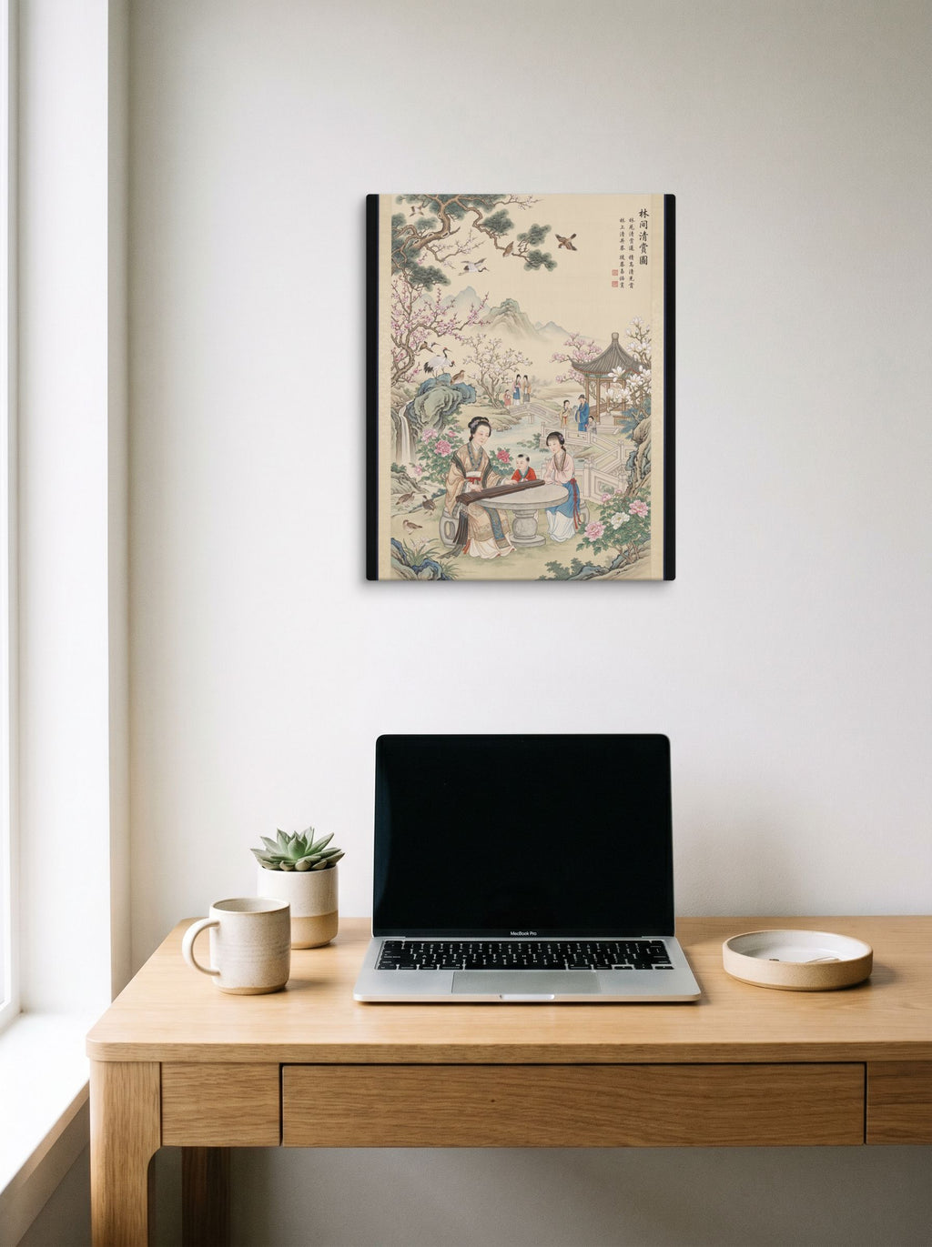 A 16x20 inch canvas Fine Art print of 'Melody in the Spring Garden' hanging above a worktable with a laptop.