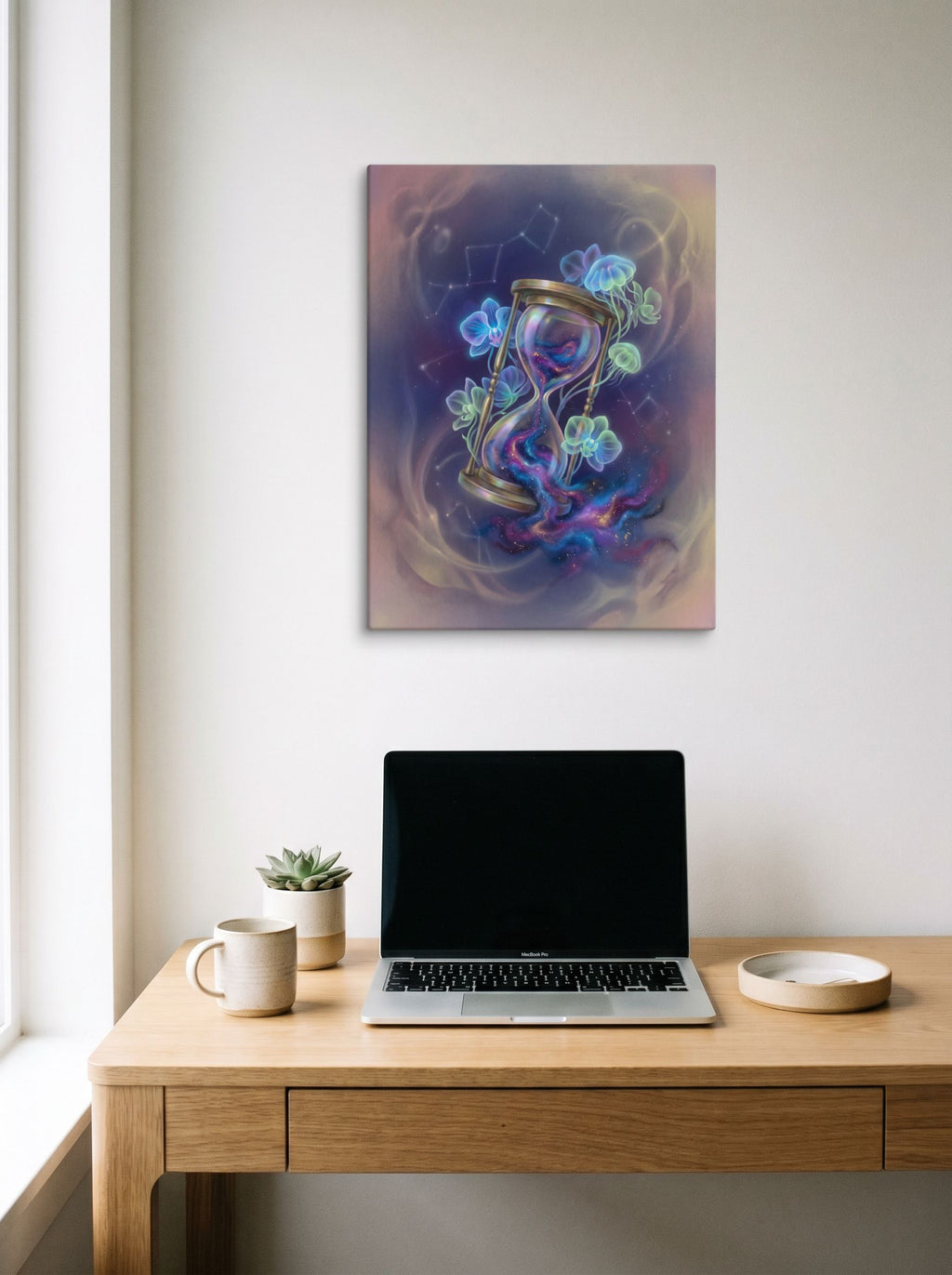 A 18x24 inch canvas Magic realism print of 'Sands of the Nebula' hanging above a worktable with a laptop.