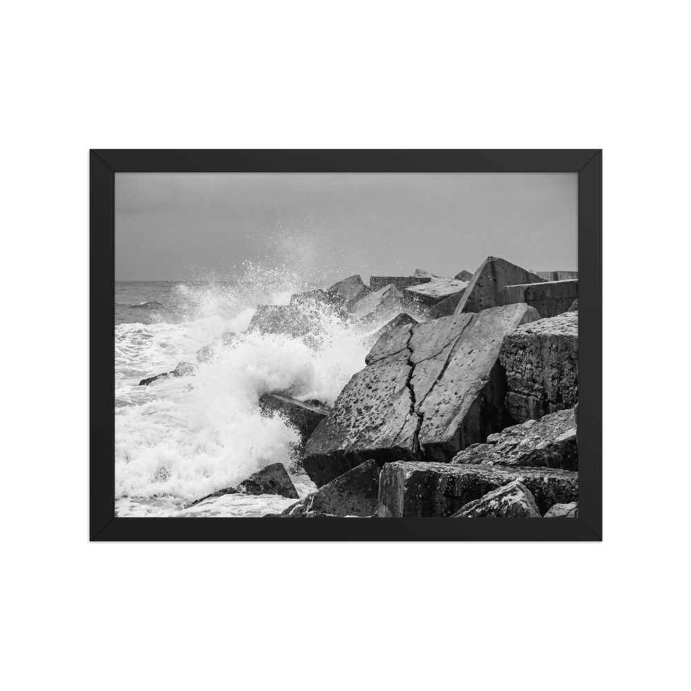 'Breakwater Surge' — a Art photography print. Monochrome ocean spray crashing against geometric stone blocks, ideal coastal decor for a modern office.