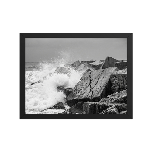 'Breakwater Surge' — a Art photography print. Monochrome ocean spray crashing against geometric stone blocks, ideal coastal decor for a modern office.