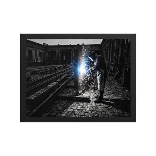 'Sparks of Labor' — a Art photography print. Dramatic high-contrast photograph of a welder generating brilliant sparks in an industrial yard, great for a garage or study.