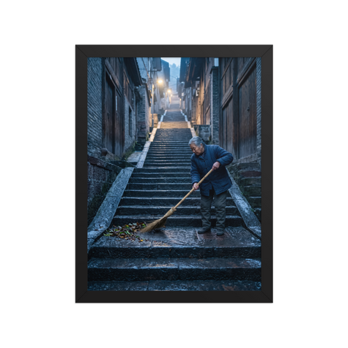 Wall art print 'Dawn on the Steps' in a Art photography style. An elderly woman sweeps stone stairs in a quiet atmospheric alleyway, bringing a sense of peaceful contemplation suited for a hallway.