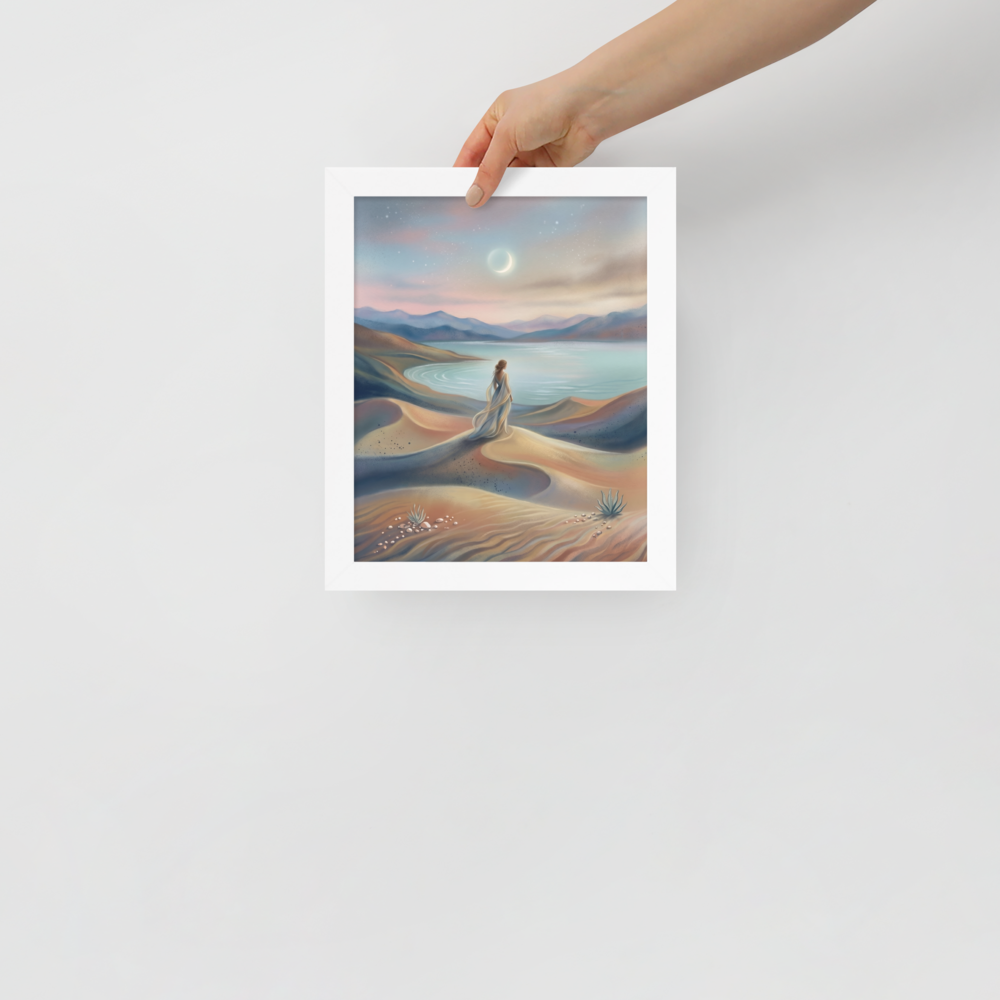 'Desert Moonrise' — a Magic realism print. A woman in a flowing dress standing on rolling sand dunes looking over a turquoise bay toward mountains under a twilight sky with a crescent moon.