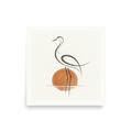 'Heron at Sunset' — a Minimalism,Modern European ink painting print. A minimalist line drawing of a heron standing in water against a watercolor orange sun, set on a textured white background. Ideal for a calming bathroom or bedroom.