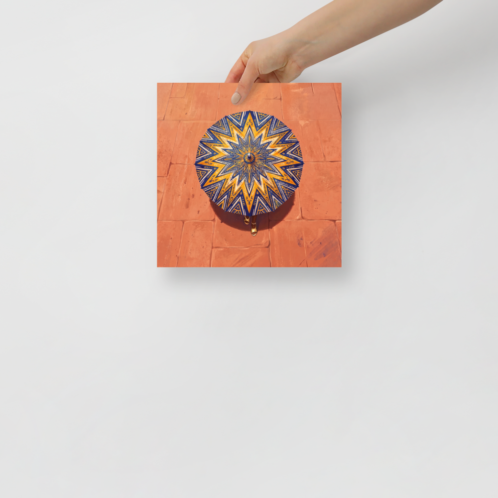 'The Patterned Parasol' — a Geometric abstract art,Figurative art print. Aerial overhead view of a woman walking with an intricate navy and yellow geometric parasol over warm terracotta pavement, ideal for Entryway wall art.