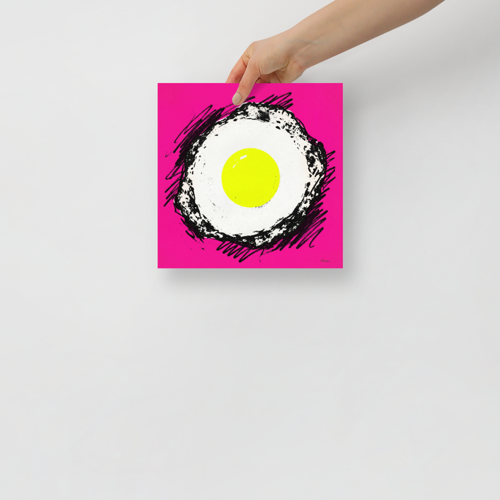 'Sunny Side Pop' — a Pop art print. A vibrant pop art illustration of a fried egg with a bright yellow yolk and sketchy black outlines, set against a solid hot pink background, perfect for a modern kitchen.