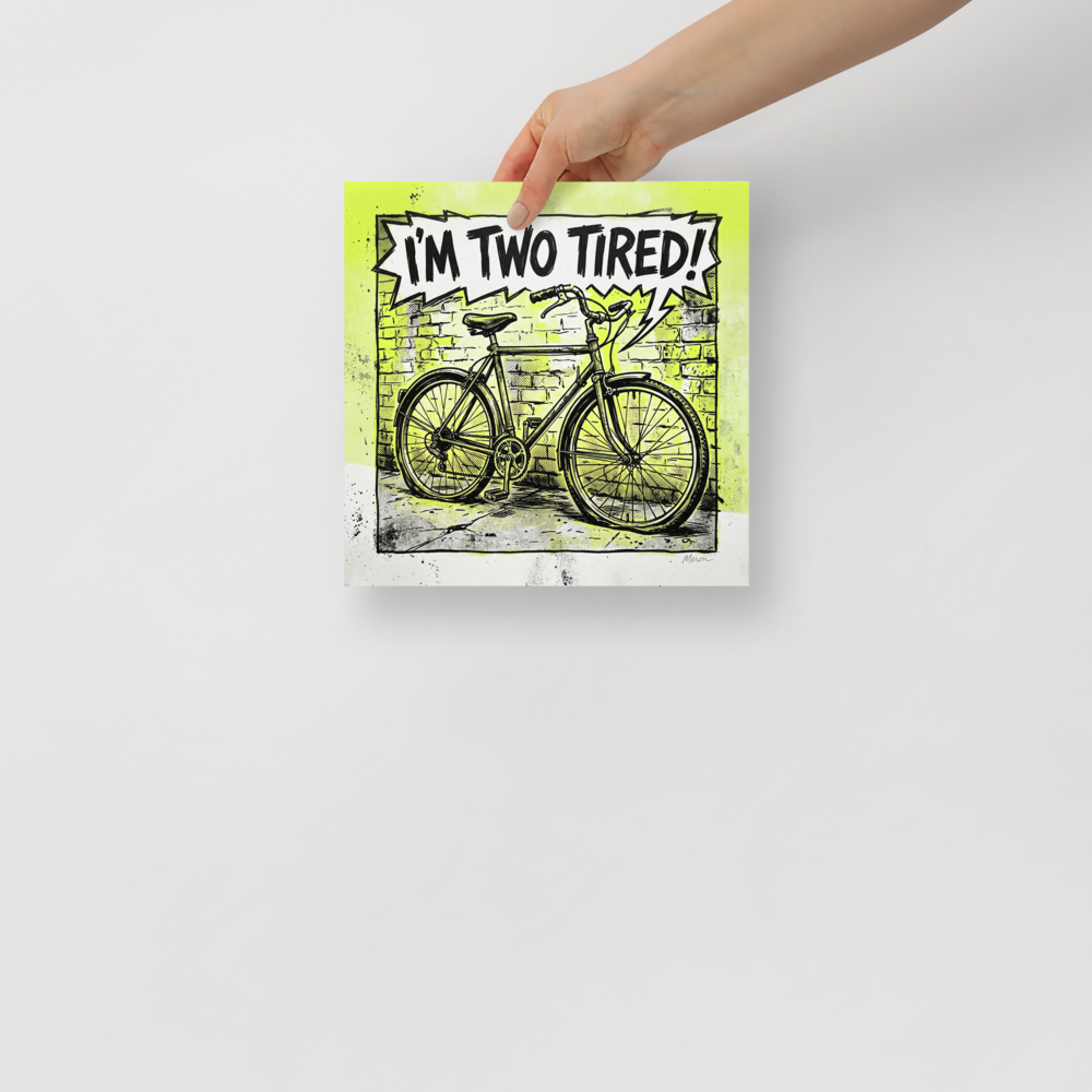 'Two Tired' — a Pop art print. A comic book style pop art illustration of a bicycle against a brick wall with lime green accents and a speech bubble reading 'I\'M TWO TIRED!', perfect for a home gym or garage.