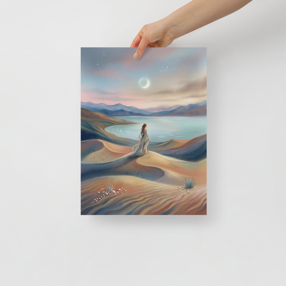 'Desert Moonrise' — a Magic realism print. A woman in a flowing dress standing on rolling sand dunes looking over a turquoise bay toward mountains under a twilight sky with a crescent moon.
