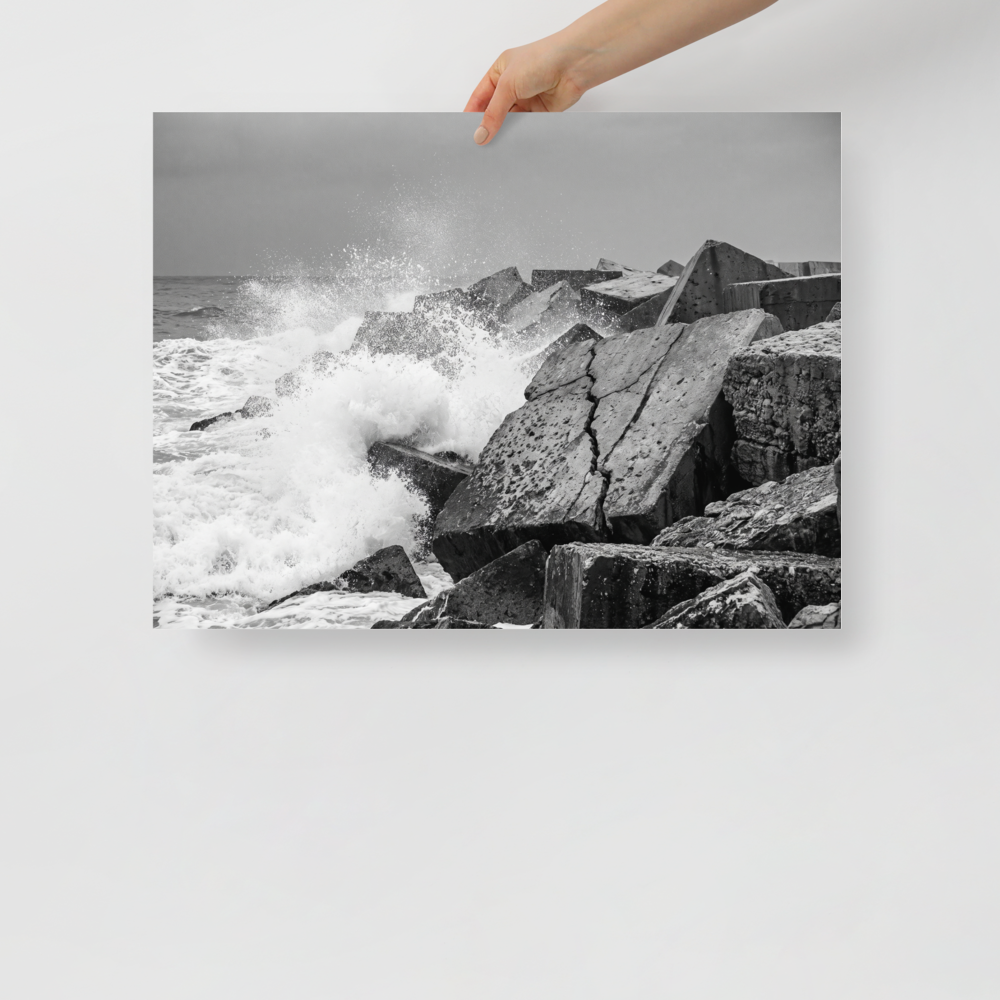 'Breakwater Surge' — a Art photography print. Monochrome ocean spray crashing against geometric stone blocks, ideal coastal decor for a modern office.