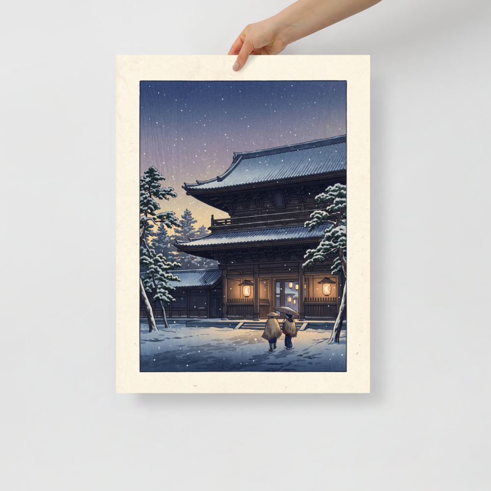 'Snowfall at Dusk' — a Shin hanga print. Two figures walk through falling snow toward an illuminated Japanese temple gate at dusk, creating a peaceful scene ideal for a living room.