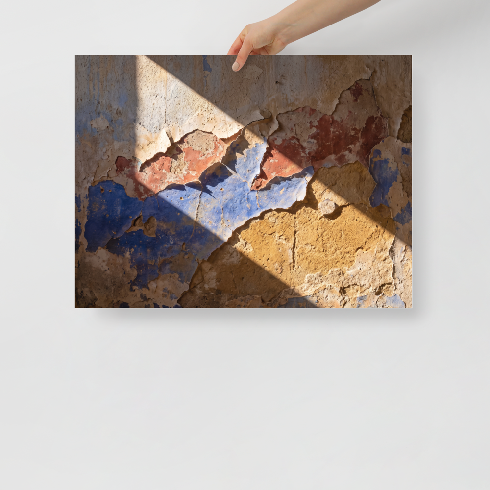 'Palimpsest in Sunlight' — a Art photography print. A photographic study of peeling plaster wall showing layers of blue, red, and ochre paint under bright diagonal sunlight, suitable for a rustic or modern living room.