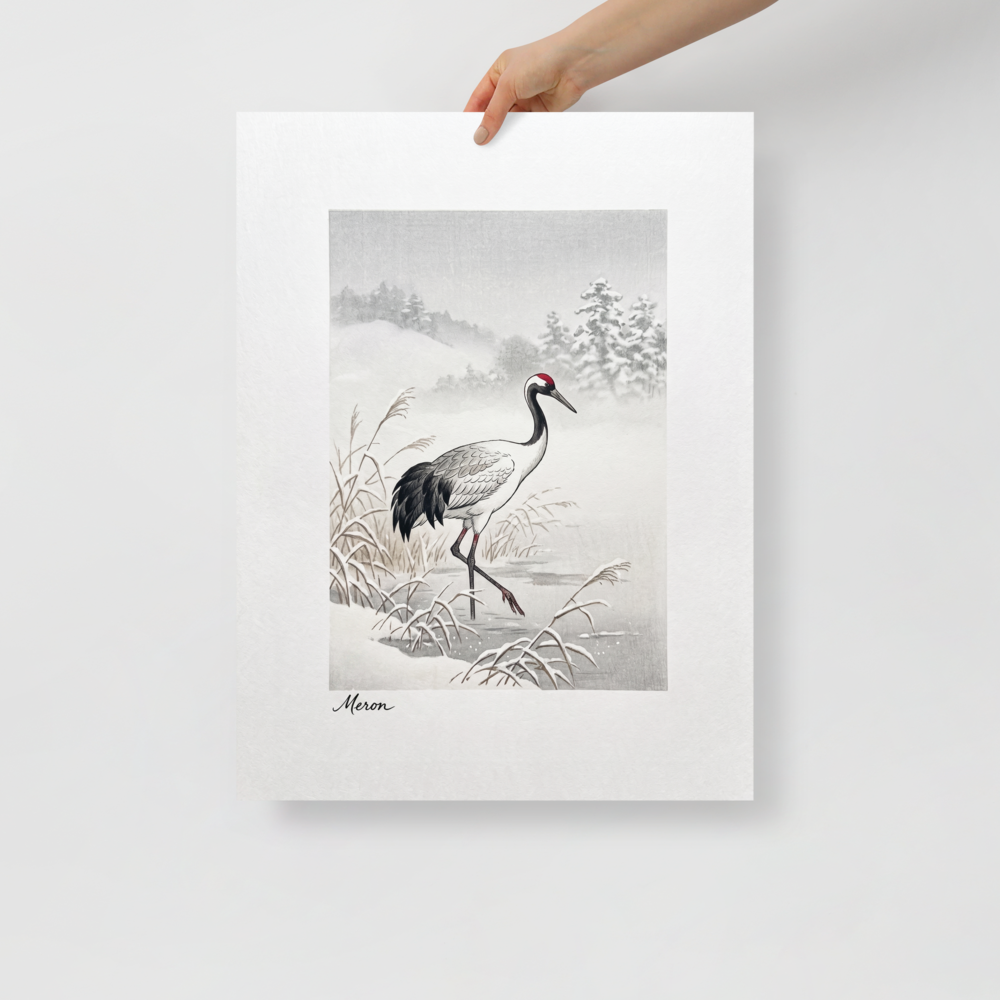 'Crane in the Frost' — a Shin hanga print. A red-crowned crane wades through a snow-covered winter marsh near frosted pine hills, adding a calm atmosphere to a bedroom.