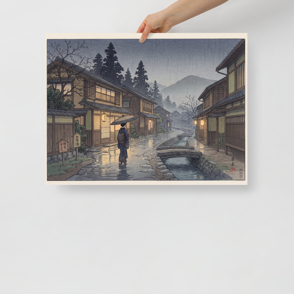 'Rain on Stone Street' — a Shin hanga print. A woman holding an umbrella walks down a rain-glistening cobblestone street beside a canal in a traditional Japanese village at twilight, perfect for a hallway.