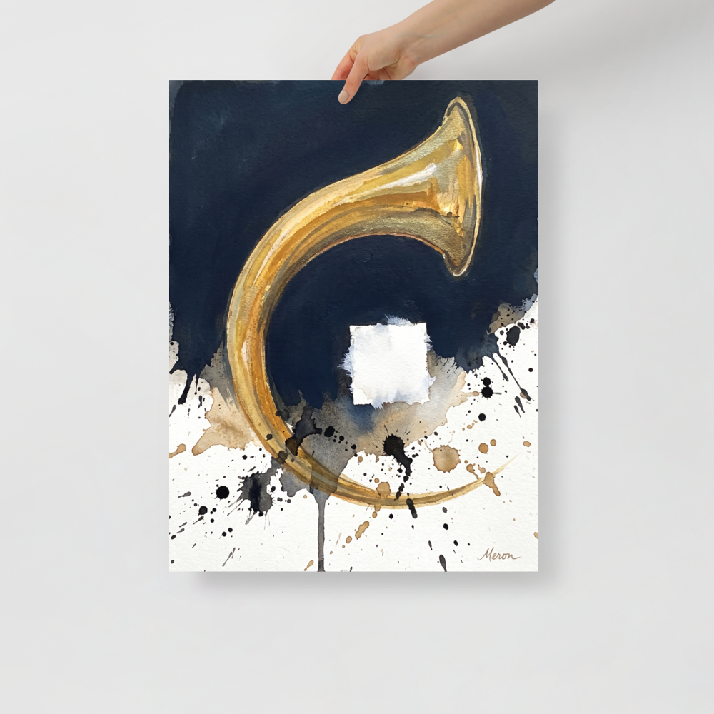 A metallic gold brass horn arc with dark blue ink wash and black ink splatters on white paper in a living room wall art display. A Abstract expressionism print in gold and navy, 'Crescendo in Gold'.