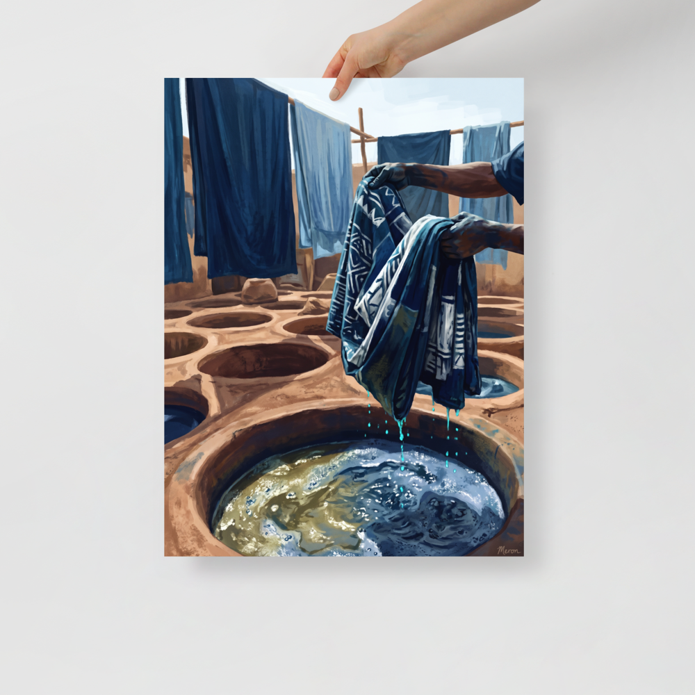 'The Indigo Dyer', a Realism wall art print. Artisan hands lifting patterned blue cloth from a sunlit clay indigo dye pit, suitable for an artist studio.