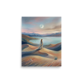 'Desert Moonrise' — a Magic realism print. A woman in a flowing dress standing on rolling sand dunes looking over a turquoise bay toward mountains under a twilight sky with a crescent moon.