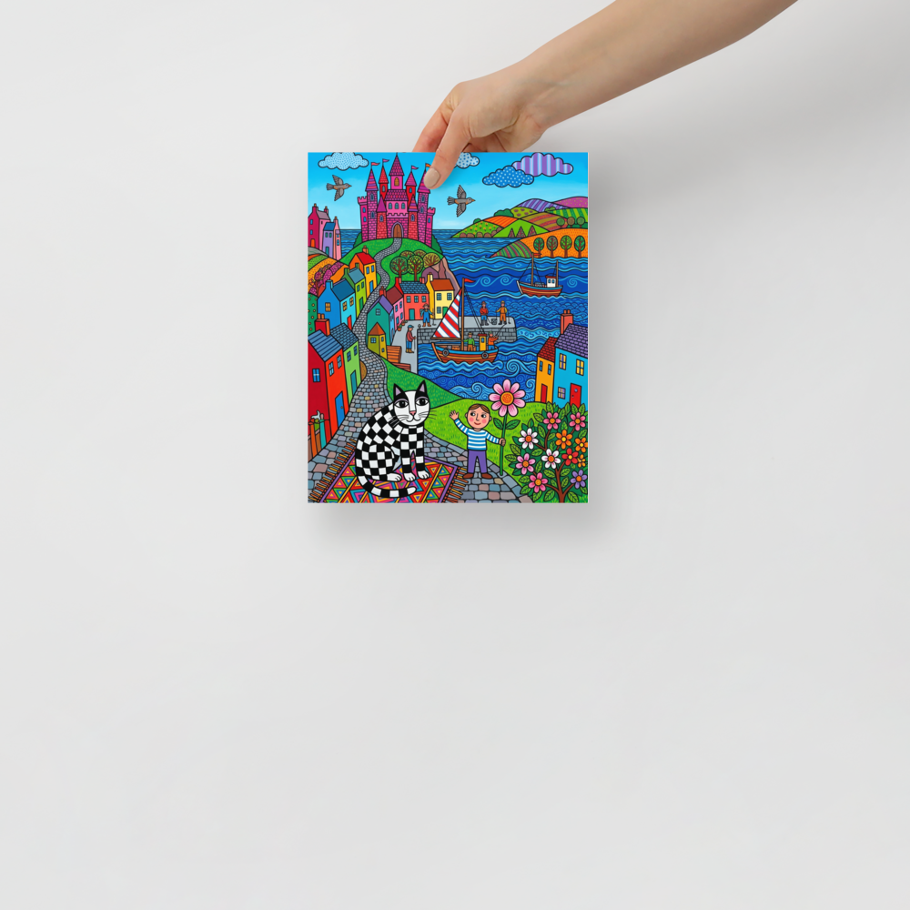 'Checkered Cat's Castle Dream' — a Naive art print. A colorful naive art scene featuring a black and white checkered cat sitting on a patterned rug in a playroom, with a seaside village and pink castle in the background.