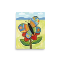 'The Patchwork Butterfly' — a Naive art print. A colorful, patchwork-style butterfly resting on a red flower in a bright meadow, perfect for a cheerful nursery or sunroom.