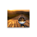 'Inverted Sunset' — a Surrealism print. A glass sphere resting on wood, refracting an upside-down golden sunset landscape.