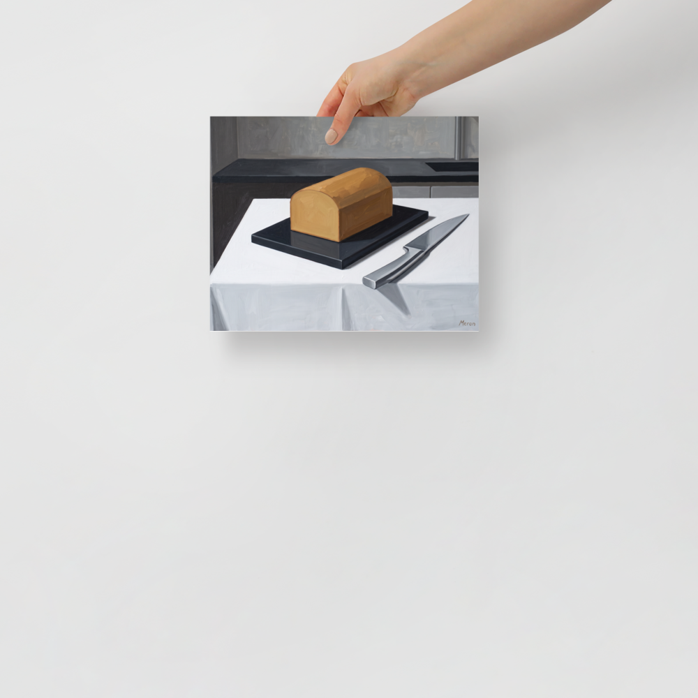 'The Morning Loaf' — a Art Deco print. A minimalist Art Deco oil painting of a golden loaf of bread and a silver knife on a crisp white table, perfect for a modern kitchen.