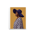 'Grace in Indigo' — a Realism,Figurative art print. An oil painting portrait of an elder African woman wearing a wide indigo hat and chevron robe against a yellow background, ideal for a peaceful bedroom or living room.
