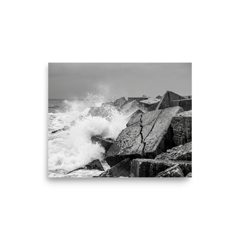 'Breakwater Surge' — a Art photography print. Monochrome ocean spray crashing against geometric stone blocks, ideal coastal decor for a modern office.