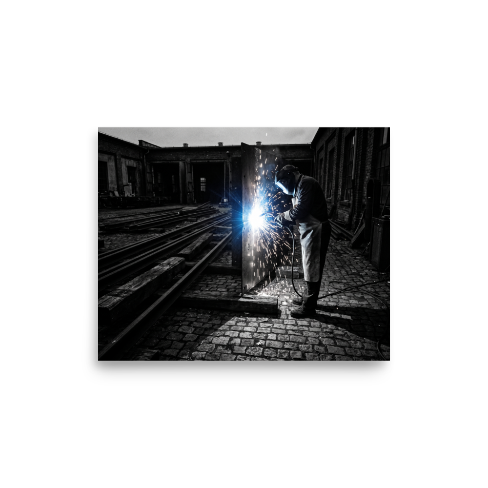 'Sparks of Labor' — a Art photography print. Dramatic high-contrast photograph of a welder generating brilliant sparks in an industrial yard, great for a garage or study.