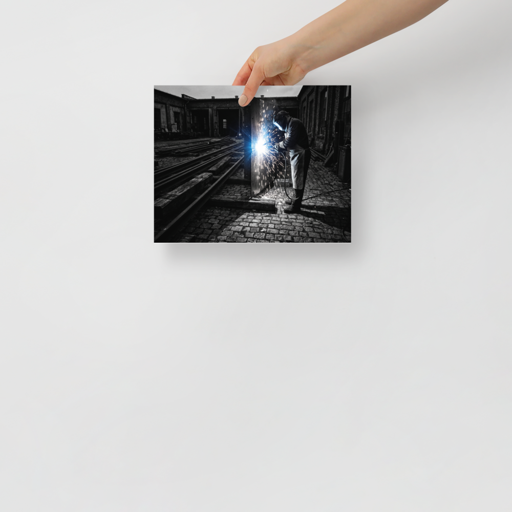'Sparks of Labor' — a Art photography print. Dramatic high-contrast photograph of a welder generating brilliant sparks in an industrial yard, great for a garage or study.
