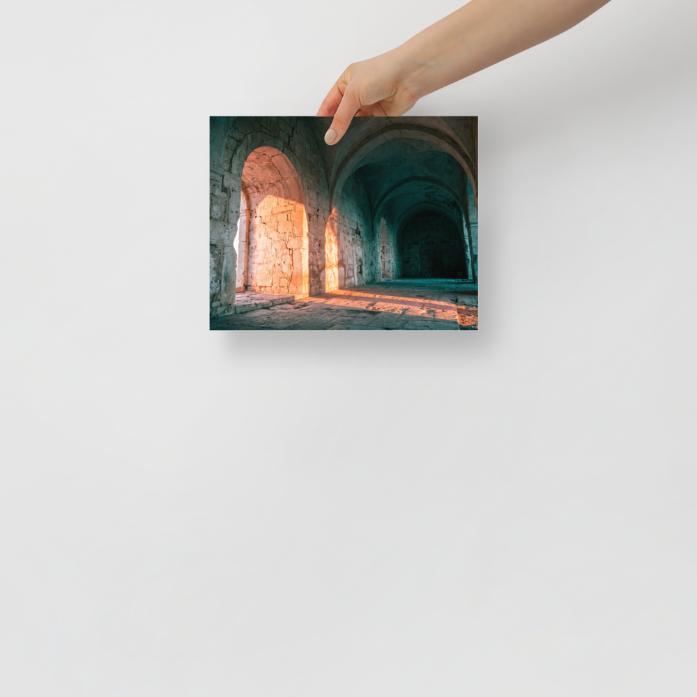 'Arches at Sunset' — a Art photography print. Ancient stone arches illuminated by warm sunset light with cool shadowed corridors, elegant architectural art for a hallway.