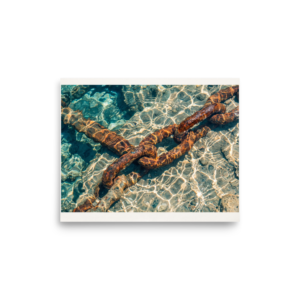 'Sunken Mooring Chain' — a Art photography print. Rusted iron mooring chain submerged in crystal clear turquoise ocean water with dancing sun ripples, ideal coastal art for a bathroom.