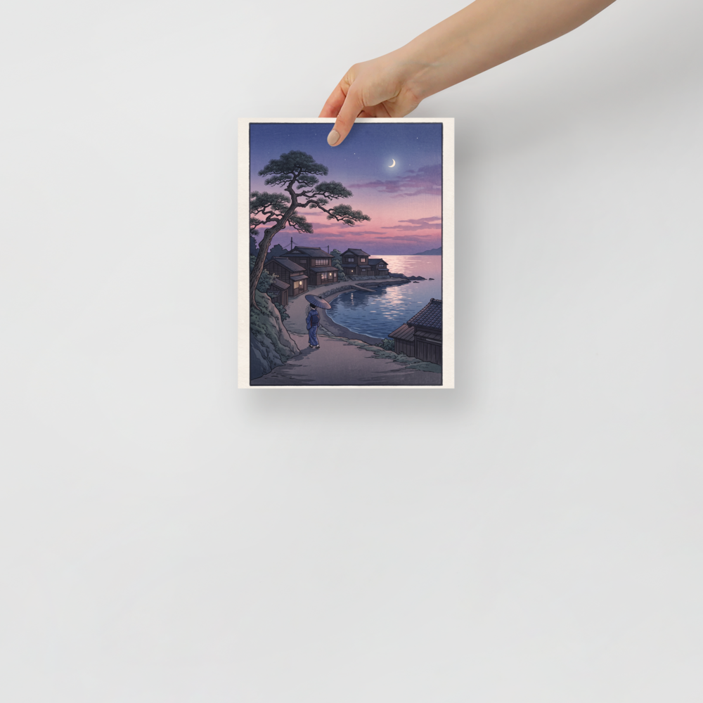 'Crescent Moon Bay' — a Shin hanga print. A woman holding an umbrella walks along a coastal village path beneath a crescent moon and twilight sky, making it a peaceful addition to a bedroom.
