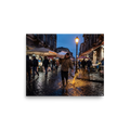 'Market Rain at Dusk' — a Art photography print. Market worker carrying a fish crate splashing through rainy wet cobblestones under a glowing streetlamp at dusk, atmospheric street photography.